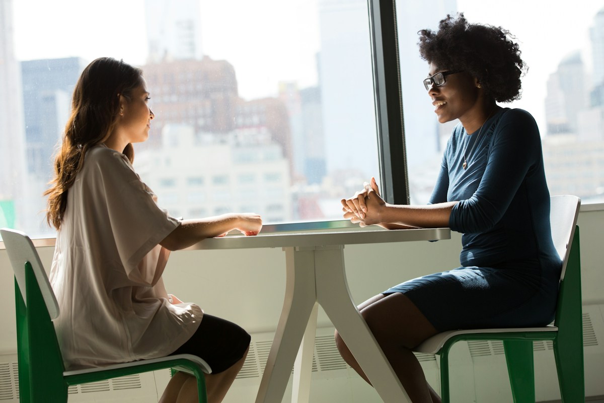 Two business professionals discussing a project at a table